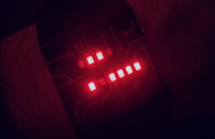 Binary watch in the dark showing the time as 6:47.
